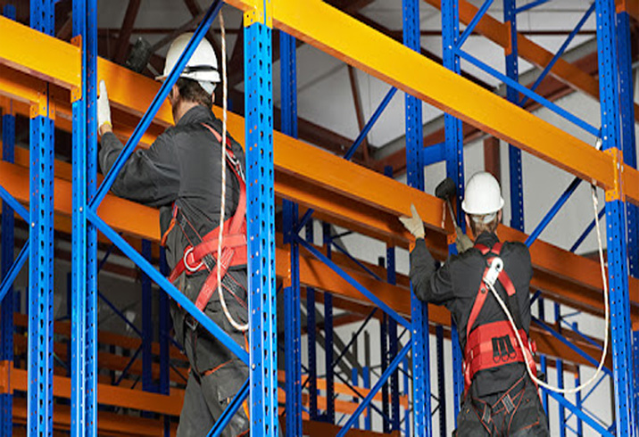 Professional team installing pallet racking system in an industrial warehouse