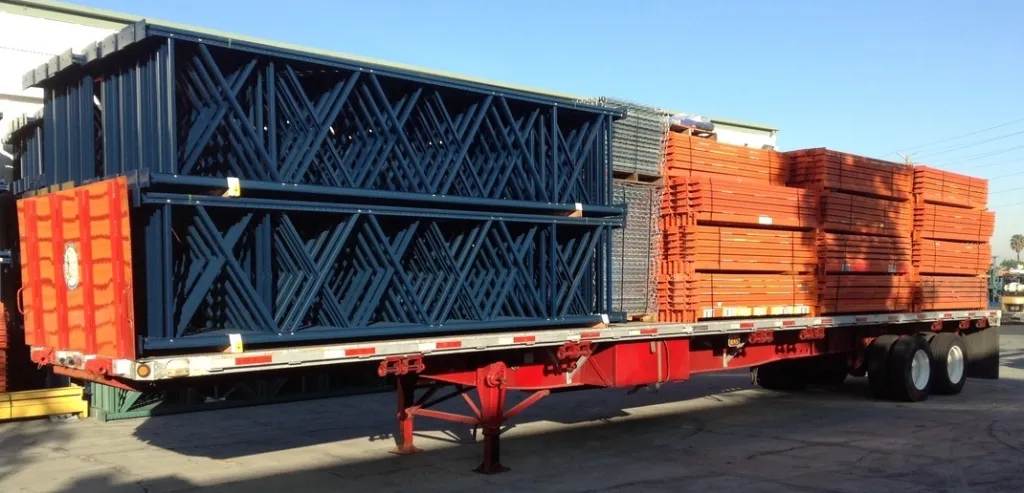Technicians dismantling and relocating industrial warehouse racking system in UAE